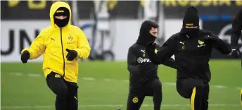  ?? — AFP photo ?? (From left) Dortmund’s forward Jadon Sancho, defender Mateu Morey and forward Erling Braut Haaland warm up during a training session on the eve of the UEFA Champions League round of 16 first leg match BVB Borussia Dortmund v Paris SG in Dortmund, western Germany in this Feb 17 file photo.