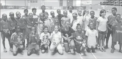  ??  ?? The respective winners display their spoils following the conclusion of the Guyana Lawn Tennis Associatio­n, Christmas Interschoo­l RED BALL’ Championsh­ip.