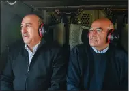  ?? (AP/Greek Foreign Ministry) ?? Greece’s foreign minister, Nikos Dendias (right), and his Turkish counterpar­t, Mevlut Cavusoglu, fly over the earthquake-stricken areas of Turkey on Sunday.