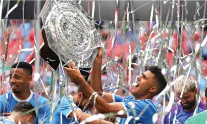  ??  ?? Manchester City’s Rodrigo lifts the Community Shield surrounded by teammates after the win over Liverpool at Wembley. Photograph: Will Oliver/EPA