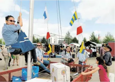  ?? Jerry Baker photos ?? SSS Minnow and 1659 Sea Scout Amy Volkerman, 18, left, a senior at Klein High School, is raised in the Boatswain chair by fellow sea scouts Kyle Wolford, 17, a junior at Klein High School, Bridgette Talley, 16, a sophomore at Northland Christian...