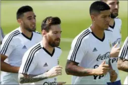  ?? RICARDO MAZALAN — THE ASSOCIATED PRESS ?? Marcos Rojo, right, and Lionel Messi jog during a training session of Argentina at the 2018 soccer World Cup in Bronnitsy, Russia, Thursday.