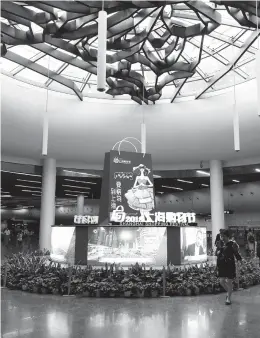  ??  ?? A Shanghai Shopping Festival installati­on is seen in People’s Square Metro station yesterday. — Jiang Xiaowei