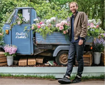  ??  ?? Flourishin­g: Freddie Garland, of Freddie’s Flowers, with one of his firm’s trucks