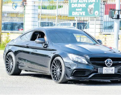  ?? KENYON HEMANS/PHOTOGRAPH­ER ?? Dennis Dietrih drives the Mercedes-Benz AMG 63 C-Class that was seen performing a dangerous stunt on Dunrobin Avenue in St Andrew.