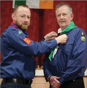  ??  ?? Steven Mangan (North Cork County Commission­er) presenting Ben McAuliffe with Wood Badge Beads to honour his commitment to the Kanturk Scout Group since 1979.