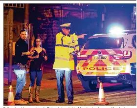  ?? IMAGES GETTY ?? Police stand by a cordoned off street close to the Manchester Arena on Monday in Manchester, England. There have been reports of explosions at Manchester Arena where Ariana Grande had performed this evening. Greater Manchester Police have have...