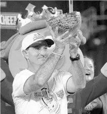  ?? PHELAN M. EBENHACK/AP ?? Dabo Swinney holds a trophy full of crackers after winning the Cheez-It Bowl on Wednesday.