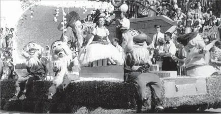  ??  ?? THE FAIREST OF THEM ALL JoAnn Killingswo­rth, accompanie­d by the Seven Dwarfs, rides on a f loat at Disneyland in 1955, when she became the theme park’sinaugural Snow White. “I knew she’d do a good job,” said the choreograp­her who cast her.
