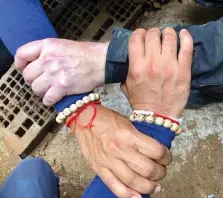  ??  ?? A photo released via the Thailand Navy SEAL Facebook page shows rescuers hands locked with a caption reading “We Thai and the internatio­nal teams join forces to bring the young Wild Boars home”. (Photo: AP) Top: the members of the football team