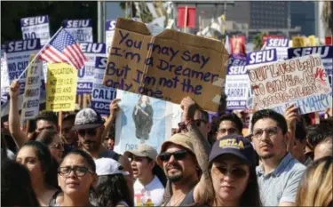  ?? RICHARD VOGEL — ASSOCIATED PRESS ?? Supporters of the Deferred Action for Childhood Arrivals, or DACA, chant slogans and hold signs while joining a Labor Day rally in downtown Los Angeles on Monday.
