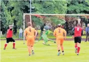  ??  ?? Netbuster Malcolm Scott is helpless as Eaglesham score their second from the penalty spot