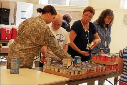  ?? REBECCA BLANCHARD — DIGITAL FIRST MEDIA ?? Daniel Boone Area High School students in the Life Skills program have been visiting the Pottstown Salvation Army each month to help prepare for the food pantry. Last week, these students were joined by several of their peers from the high school’s newly formed Junior Reserve Officer Training Corps program.