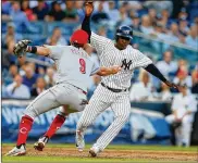  ?? JIM MCISAAC / GETTY IMAGES ?? Cincinnati’s Jose Peraza tags New York’s Didi Gregorius for the third out of a second-inning triple play Tuesday night at Yankee Stadium.