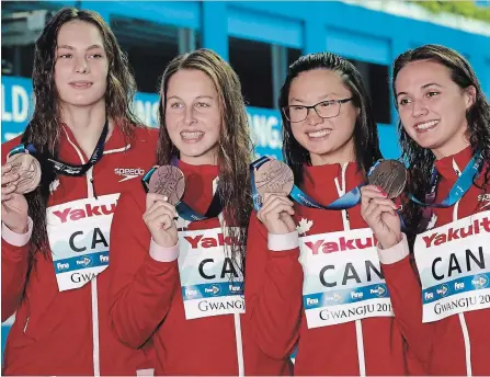  ?? LEE JIN-MAN THE ASSOCIATED PRESS ?? The Canadian women’s 4x100-metre medley relay team pose with their bronze medals at the world swimming championsh­ips in Gwangju, South Korea, on Sunday. The Canadian swimmers ended the competitio­n with a team record two gold and six bronze, all in Olympic events.