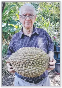  ?? ?? John Marshall with a 6kg durian on his farm at Barron Falls Estate in Kuranda, where he has farmed durian for 47 years. The fruit normally doesn't exceed 2-3kg.