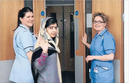  ?? Photo: REUTERS ?? Starting life again: Pakistani schoolgirl Malala Yousufzai waves, accompanie­d by nurses, as she is discharged from the Queen Elizabeth Hospital in Birmingham.