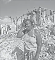  ?? PATRICK FARRELL, AP ?? Cholera Marie Louse Valentin weeps in front of her home shattered by Hurricane Matthew in Morne la Source, Haiti. More than 50,000 people still remain in temporary camps.