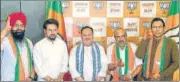  ?? ANI ?? Union minister Anurag Thakur and BJP chief JP Nadda welcome new party members Anoop Kesari, Satish Thakur and Iqbal Singh, in New Delhi on Friday.