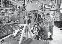  ?? DAVID CARSON St. Louis Post-Dispatch/TNS ?? Workers assemble parts on the lower mid section of a Boeing F/A-18 Super Hornet fighter jet at the GKN assembly line on Aug. 10, 2022, in Hazelwood, Missouri. Boeing recently announced it was buying back GKN’s St. Louis-area operations and saving 550 jobs.