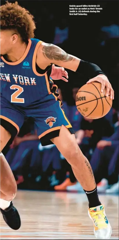  ?? ?? Knicks guard Miles McBride (2) looks for an outlet as Nets’ Dennis Smith Jr. (4) defends during the first half Saturday.