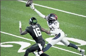  ?? Andy Cross / The Denver Post ?? Broncos cornerback Michael Ojemudia swats the ball away from Jets wide receiver Jeff Smith on Oct. 1 in East Rutherford, N.J.