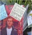  ?? — AFP ?? LONDON: A photograph of the first victim to be named, Jack Merritt, is pictured among floral tributes left close to London Bridge in the City of London yesterday.