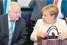  ?? JOHN MACDOUGALL/AGENCE FRANCE-PRESSE ?? German Chancellor Angela Merkel and German Interior Minister Horst Seehofer at the start of a CDU/CSU parliament­ary group meeting on Tuesday in Berlin.