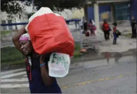  ?? DAVID GOLDMAN — THE ASSOCIATED PRESS ?? Evacuees are moved to another building with more bathrooms while sheltering at Florida Internatio­nal University ahead of Hurricane Irma in Miami, Saturday.