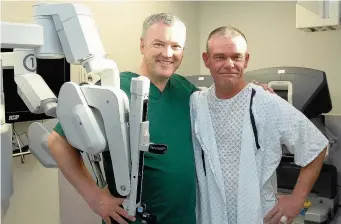  ??  ?? Surgeon Neil Oakley and patient Victor Unwin with the robot