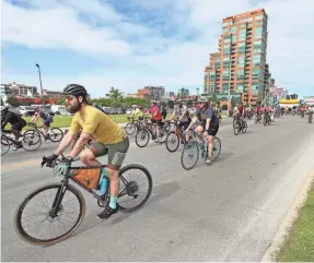  ?? SAM UPSHAW JR./COURIER JOURNAL ?? Cyclists hit the road for the bicycle portion of the Hike, Bike & Paddle 2023 at Waterfront Park in Louisville on May. 29, 2023.