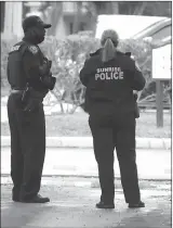  ?? Associated Press photo ?? Police officers work near the scene of a shooting that wounded several FBI agents in Sunrise, Fla., Tuesday.