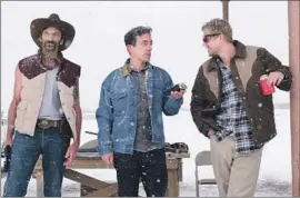  ?? Patti Perret Focus Features ?? B.J. NOVAK, playing Ben, a New Yorker writer chasing a story in small-town Texas, is flanked by Clint Obenchain, left, and Boyd Holbrook in “Vengeance.”