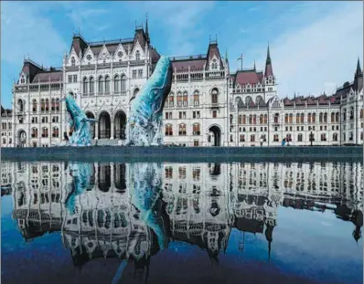  ?? ZSOLT SZIGETVARY / MTI VIA AP ?? Whale sculptures made from plastic waste that was recovered from the ocean are on display at the parliament building in Budapest, Hungary, on July 9, 2019.