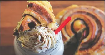  ??  ?? Different varieties of cinnamon rolls are offered each day at Eva and Delilah’s Bakery, such as this maple bacon version.