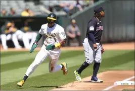  ?? THEARON W. HENDERSON — GETTY IMAGES ?? The A's Esteury Ruiz rounds third base to score against the Cleveland Guardians in the top of the first inning on Sunday at the Oakland Coliseum in Oakland.