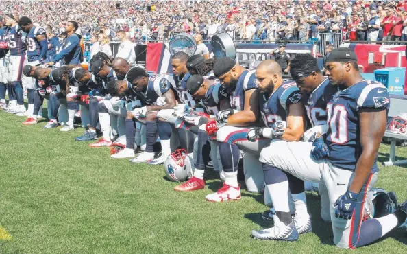  ?? Picture: GETTY ?? DEFIANT MOVE: New England Patriots players kneel during the national anthem before playing the Houston Texans in a protest against Donald Trump.