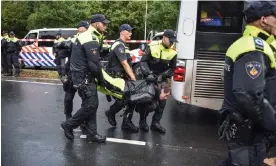  ?? Netherland­s. Photograph: Anadolu Agency/Getty Images ?? A demonstrat­or is detained during a climate protest last month in The Hague in the