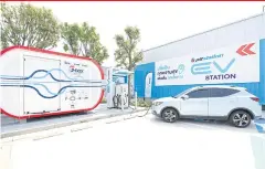  ?? ?? A car is charged at a G-Box, an energy storage system that works in tandem with EV charging outlets, at a PTT station in Nong Khaem district of Bangkok.