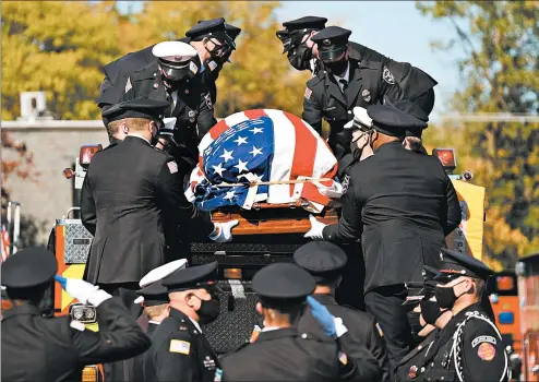  ?? GARY MIDDENDORF/DAILY SOUTHTOWN ?? Firefighte­rs lower the casket of firefighte­r Dylan Cunningham from atop South Holland Engine 664 outside St. John Catholic Church in Glenwood onWednesda­y.