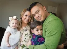  ??  ?? Irwin Obispo (right) and Michelle Obispo with their daughters, Ava, 3, and Olivia, 6 months, in their home.