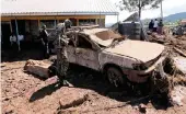  ?? PICTURE: REUTERS/AFRICAN NEWS AGENCY (ANA) ?? A military officer assesses a damaged car on Thursday after a dam burst the day before, flooding homes and killing 44 people in the town of Solai near Nakuru, Kenya.