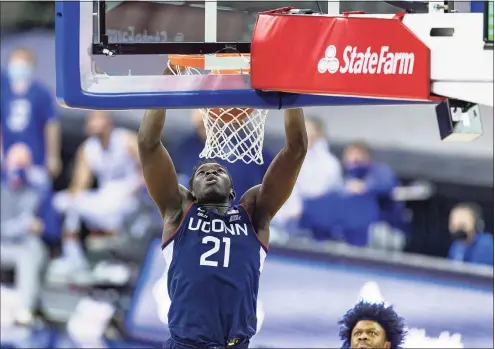  ?? John Peterson / Associated Press ?? UConn’s Adama Sanogo dunks against Creighton.