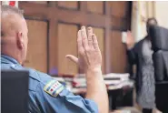  ?? ANTONIO PEREZ/CHICAGO TRIBUNE ?? Chicago Police Officer Joseph McElligott raises his right hand as he prepares to testify during the opening statements in the first-degree murder trial of a fellow officer.