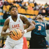  ?? SCHUERMAN/STAFF PHOTOS
BILLY ?? Lake Taylor’s Elijah Washington powers past James Monroe’s Michael Edwards during a Class 3 state semifinal on Friday night at Echols Hall in Norfolk. Washington finished with 28 points and 19 rebounds.