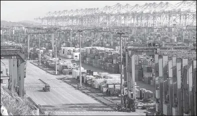  ?? REUTERS ?? Containers are seen at the Yangshan Deep Water Port, part of the Shanghai Free Trade Zone, in Shanghai, China.