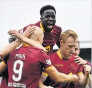  ??  ?? Joy Boys Motherwell players celebrate Johnson’s goal