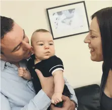  ??  ?? Parents Martin Dawes and Vicky Curry with Theo.