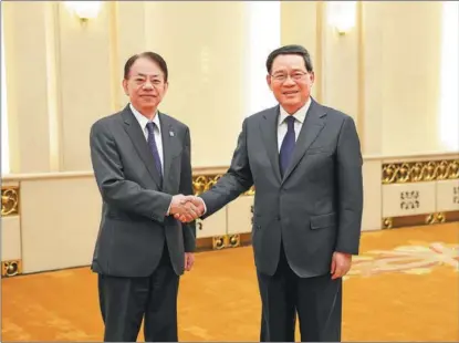 ?? FENG YONGBIN / CHINA DAILY ?? Premier Li Qiang (right) meets with Masatsugu Asakawa, president of the Asian Developmen­t Bank, in Beijing, on July 11. Asakawa arrived in China on July 9 in his first visit to the nation since he took office as the ADB’s 10th president on Jan 17, 2020.
