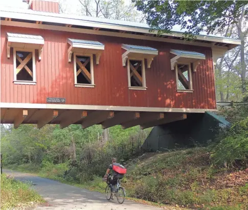  ?? RAILS-TO-TRAILS CONSERVANC­Y ?? Ohio’s Little Miami Scenic Trail: The Yellow Springs Bridge is one of many charming sights along the way.